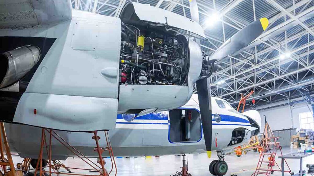Airplane undergoing regular maintenance in hangar.