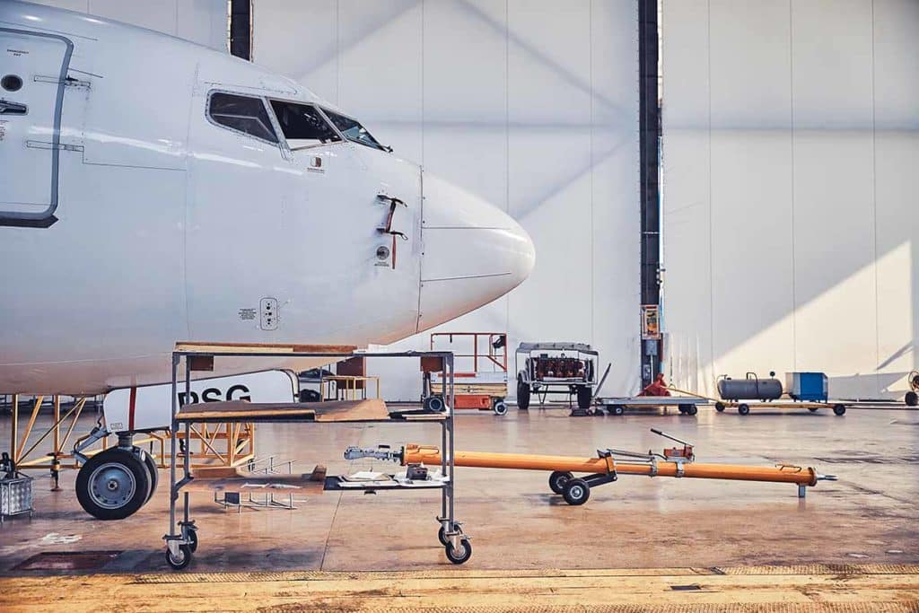 Aircraft sitting in hangar awaiting aircraft maintenance procedures. 